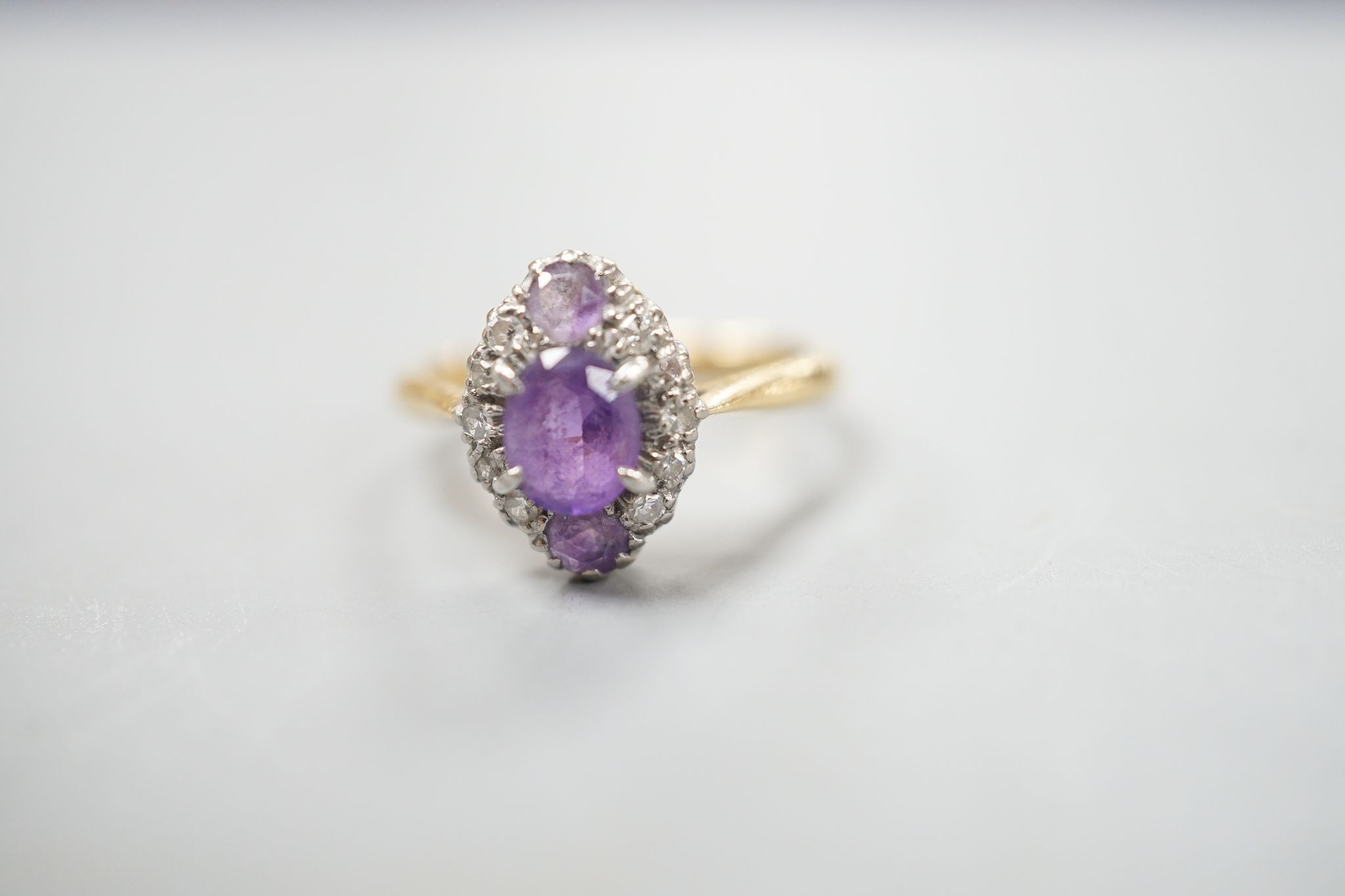 An early 20th century 18ct & plat, amethyst and diamond set marquise cluster ring, size K, gross weight 3.2 grams.